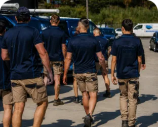 Plumbers walking to their service vans on a Rodd Point job